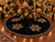 Luxury 55-inch black velvet Christmas tree skirt by SADE New York, featuring five gold rhinestone snowflakes and sparkling crystal trim beneath an elegantly decorated Christmas tree.