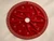Luxury red velvet Christmas tree skirt by SADE New York, featuring a sparkling geometric rhinestone border, delicate crystal motifs, red ribbon tie closures and elegant velvet folds on a warm beige studio background.