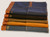 Stack of cotton canvas half aprons in black, brown, green, navy and denim color options