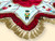 Luxury red and white velvet nutcracker Christmas tree skirt featuring embroidered toy soldiers, gold braid trim, red ruffles and gold fringe tassels.