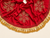 Handmade red velvet Christmas tree skirt showing intricate gold snowflake beadwork, natural fabric folds, decorative trim and center fastening ties.