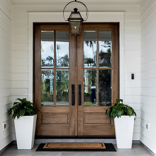 Elegant mahogany wood front door featuring clear glass panels, showcasing natural wood grain and inviting light into the home. Elegant mahogany wood front door featuring clear glass panels, showcasing natural wood grain and inviting light into the home.