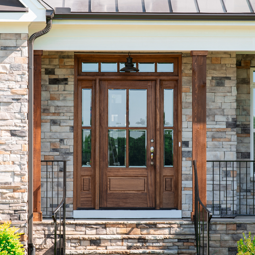 Bespoke 4 Lite mahogany entry door with clear bevel glass, sidelights, and transom. Available at Grandentrydoors.com.
