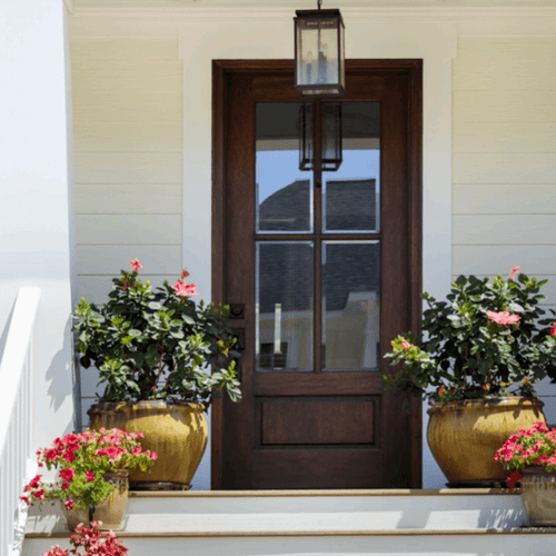 Bold 42 x 96 mahogany single door with clear bevel glass shown on a porch with beautiful potted plants. Available at Grandentrydoors.com. Bold 42 x 96 mahogany single door with clear bevel glass shown on a porch with beautiful potted plants. Available at Grandentrydoors.com.