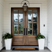 Elegant mahogany wood front door featuring clear glass panels, showcasing natural wood grain and inviting light into the home. Elegant mahogany wood front door featuring clear glass panels, showcasing natural wood grain and inviting light into the home.