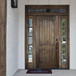 Grand Entry Doors Ventura Solid Panel Mahogany Entry Door with Sidelights and Transom | Wood Species: Mahogany, Glass (as pictured): Clear Bevel | Pictured Finished / Stained. All wooden front doors are priced and delivered as unfinished / not stained pre-hung units. No finish options available for shipped units.