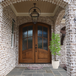 Mahogany 4 Lite arch top double front door featuring Flemish glass for soft texture, privacy, and refined architectural style. Available at GrandEntryDoors.com.