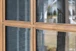 Close-up of mahogany true divided lite (TDL) profile showing precise muntin detailing, clear bevel glass, and smooth handcrafted finish. Available at GrandEntryDoors.com.