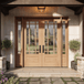Grand Entry Doors Andalucia 9-Lite True Divided Lite Double Entry Door with Sidelights | Wood Type: African Mahogany, Glass (as pictured): Clear Bevel | Pictured Finished / Stained. All wooden front doors are priced and delivered as unfinished / not stained pre-hung units. No finish options are available for shipped units. Grand Entry Doors Andalucia 9-Lite True Divided Lite Double Entry Door with Sidelights | Wood Type: African Mahogany, Glass (as pictured): Clear Bevel | Pictured Finished / Stained. All wooden front doors are priced and delivered as unfinished / not stained pre-hung units. No finish options are available for shipped units.
