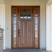 Beautiful craftsman mahogany 3 lite front door with matching 5 lite full view sidelights, showcasing rich wood grain and elegant detailing. Available at Grandentrydoors.com.