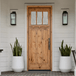 Knotty alder Craftsman single front door with three lite clear glass, vertical plank panels, and natural wood grain for a warm, inviting entry.