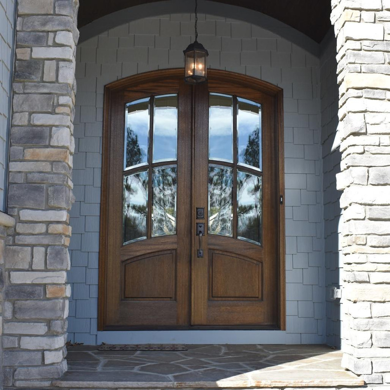 Grand Entry Doors Florencia 4 Lite True Divided Lite Arch-Top Mahogany Double Entry Door | Wood Species: Mahogany, Glass (as pictured): Clear Bevel | Pictured Finished / Stained. All wooden front doors are priced and delivered as unfinished / not stained pre-hung units. No finish options available for shipped units.