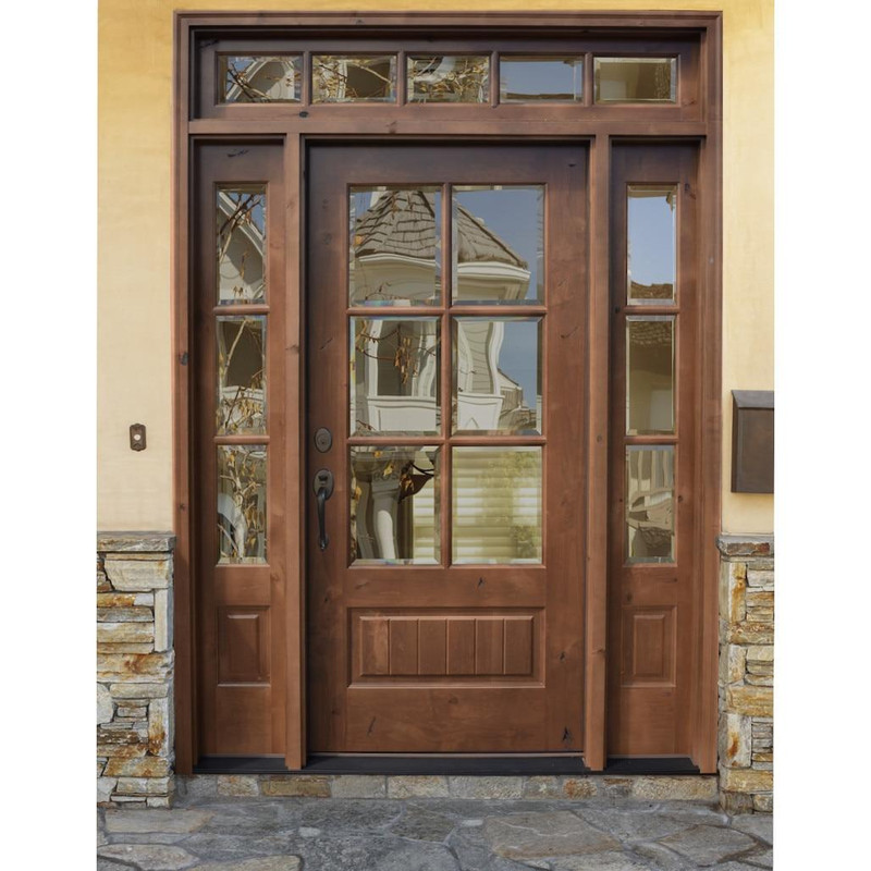 Knotty alder 6 Lite front door with sidelights and transom featuring clear bevel glass for timeless warmth, symmetry, and classic farmhouse appeal. Available at GrandEntryDoors.com.