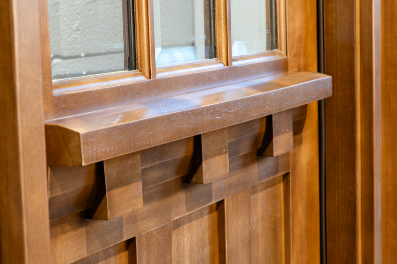 Close-up of mahogany Craftsman door dentil shelf profile showcasing classic architectural detail, clean lines, and traditional handcrafted design. Available at GrandEntryDoors.com.