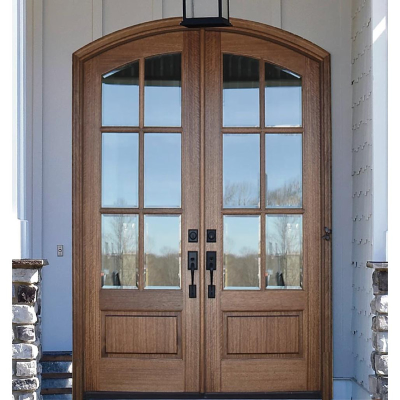 Light-finished mahogany 6 lite arch top double door with clear bevel glass enhances natural light and curb appeal. Available at Grandentrydoors.com.