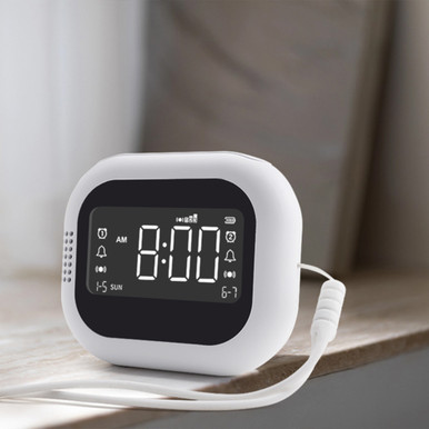Rechargeable vibration alarm clock on a bedside table