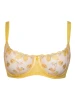 A floating balconnette bra with lemons embroidered on it. There is a little lemon charm on the gore of the bra.