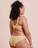 a model showing the back band of a yellow bra