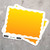 Image of stickers with a sunset gradient with a jagged white boarder and a peel tab with the words 'Brito! Peel Here' on a metal background