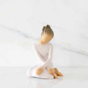 Front view: seated figure in cream dress with crossed arms
