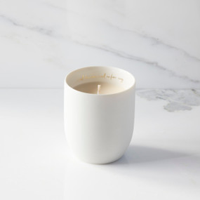 Filled scented candle with unglazed off-white tapered cylinder vessel, sentiment written in gold inside rim, plant-based wax blend, all-cotton wick.