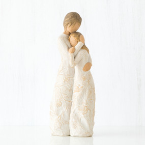 Mother faceless figurine hugging faceless daughter figurine - both standing wearing white dresses