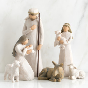 Set of two faceless woman figurines and one man figurine surrounded by laying donkey and three white sheep figurines