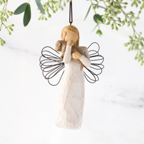 Female angel figure in cream dress with wire wings, holding brown dog in arms, ornament loop attached to head