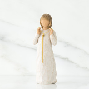 Small girl figurine wearing white dress with long gold chain holding her hands to her face