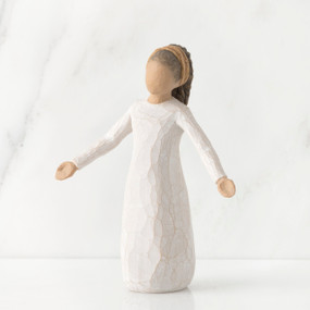 Young faceless girl figurine standing wearing all white dress with her arms out