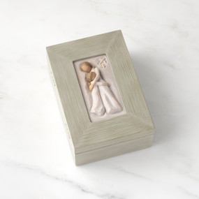 Light gray rectangular wood box with hinged lid, carving on lid of female and child embracing in cream dresses