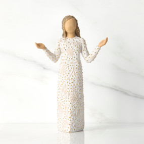 Front view of brunette girl figurine in white dress with gold dots holding her hands to the side