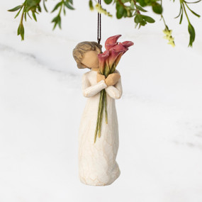 Figure in cream dress, holding tall bouquet of fuchsia calla lilies. Hook and loop affixed to figure's head