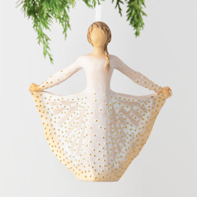 Front view, figure in cream dress, holds skirt with both hands, carved like monarch, dotted with gold. Hook, loop on ornament's head