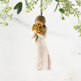 Figure in cream dress, holding large bouquet of yellow sunflowers up to face. Hook and loop affixed to figure's head