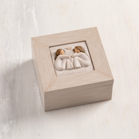 Cream wood box with hinged lid. Inset bas-relief plaque of two seated girls, facing each other.