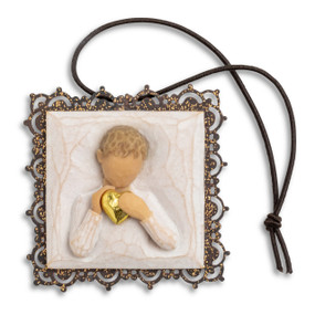 Small square bas-relief carving of boy holding gold heart, edged in pierced-metal filigree with brown elastic ornament loop