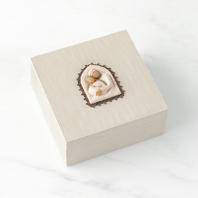 Front view: hand-painted cream square wood box with hinged lid, metal-edged bas-relief carving of Holy Family affixed to lid