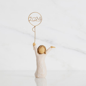 Front view: standing figure in cream dress, arms raised, holding gold wire balloon with 2024 written in gold wire inside
