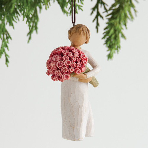 Angel figurine ornament in white dress holding pink roses