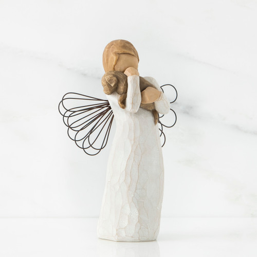 Angel figurine faceless holding brown puppy to her face - wings are wire