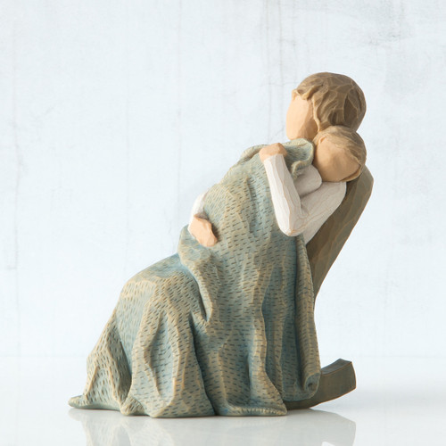 Faceless woman sitting in rocking chair holding baby wrapped in large blue blanket