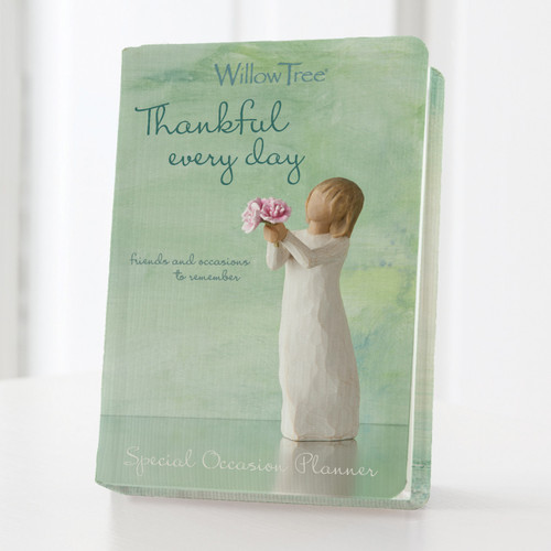 Light green standing planner book with 'thankful everyday willow tree' in darker green next to faceless girl printed on