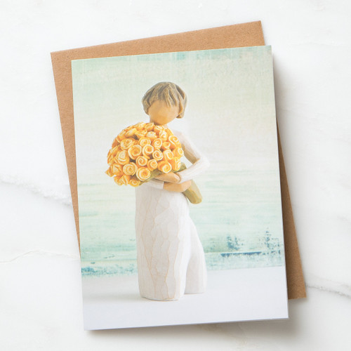 Light green notecard featuring female figure in cream dress, holding bouquet of yellow roses; blank inside, kraft envelope