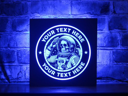 A Skeleton Astronaut LED sign featuring a skeleton named Skully in an astronaut suit, saluting. The sign has a vibrant blue glow, customizable text, and is set against a brick wall, with a durable wood frame and black acrylic front