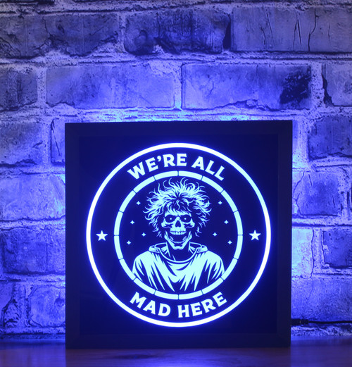 Step into the realm of the bizarre with our "Skeleton in Straitjacket" LED sign. This captivating design features a skeleton in a straitjacket, surrounded by the phrase "We're All Mad Here." Perfect for those who enjoy a touch of the macabre, this sign adds a unique edge to your space.