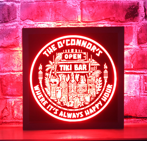 Customizable Tiki Bar LED sign in a black-stained wooden frame shadow box. The sign features vibrant tiki-themed graphics including masks, torches, and tropical cocktails, Open Tiki Bar Where It's Always Happy Hour' on a black acrylic front panel