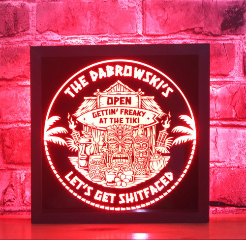 Customizable Tiki Bar LED sign in a black-stained wooden frame shadow box. The sign features vibrant tiki-themed graphics including masks, torches, and tropical cocktails, Open Tiki Bar Where It's Always Happy Hour' on a black acrylic front panel