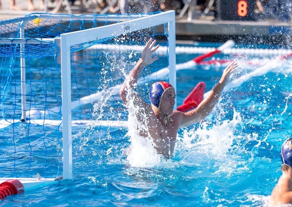 People playing water polo Goalie defending the goal