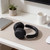 Black over-ear wireless headphones on desk
